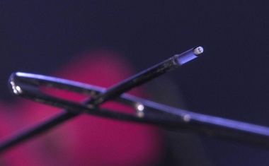 3D-printing miniaturized optics on glass fibers