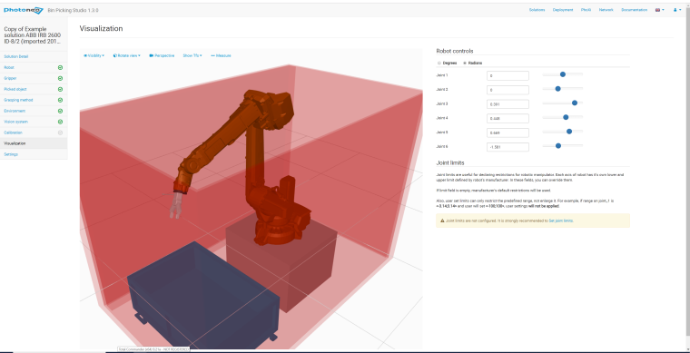 he robot takes the cut-off part out of the laser cabin and places the processed...