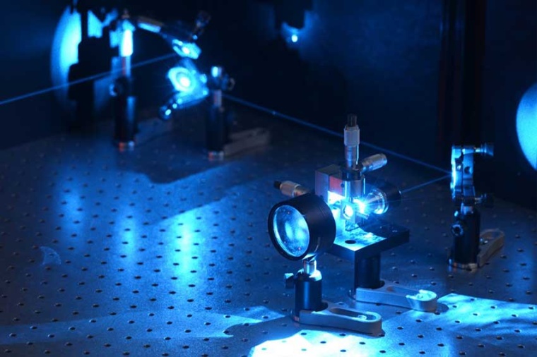 With the aid of optics, the shape of the laser beam is adjusted in interference...