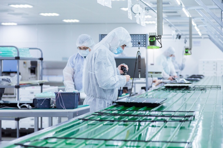 Code readers, which are permanently mounted above control stations, allow a...