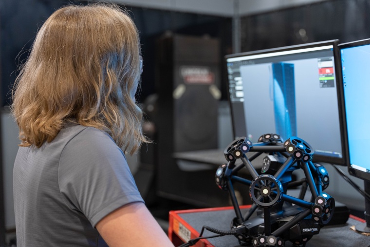 A Lincoln Electric Additive Solutions employee checks the Creaform Metrascan 3D...