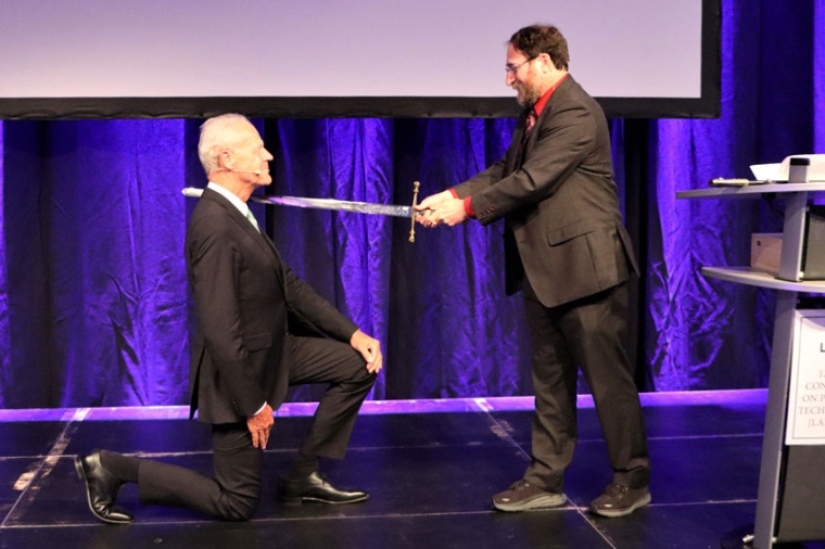 Prof Reinhart Poprawe receives the knighthood from Prof Craig Arnold (Source:...
