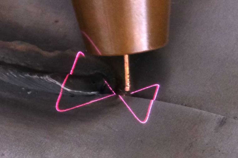 Seam tracking and seam quality inspection with OCT (pink scan lines) in...