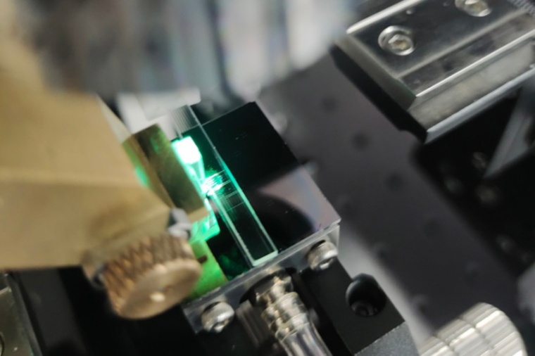 Light being focused through the microlens array onto the microring in the OPCA...