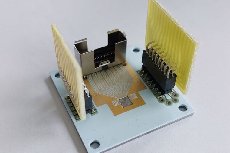 A ceramic printed circuit board (PCB) is bonded to a molybdenum heatsink. The...