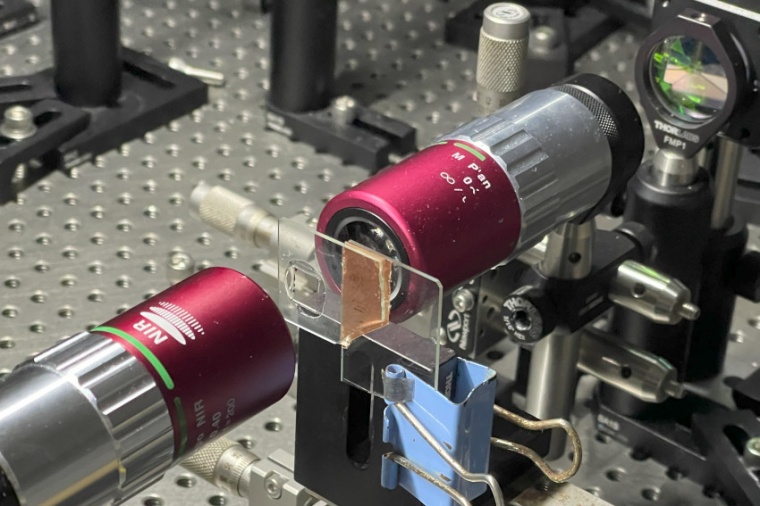 Close-up revealing how two red lens modules align with a glass plate, carefully...