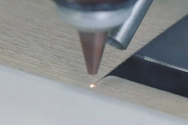 Close-up of laser cutting crepe paper for the electrical transformer industry...