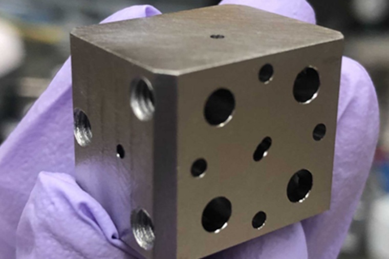 A niobium superconducting cavity. The holes lead to tunnels which intersect...
