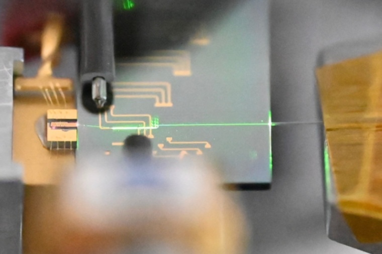Optical image of the chip-scale ultrafast mode-locked laser when operating....