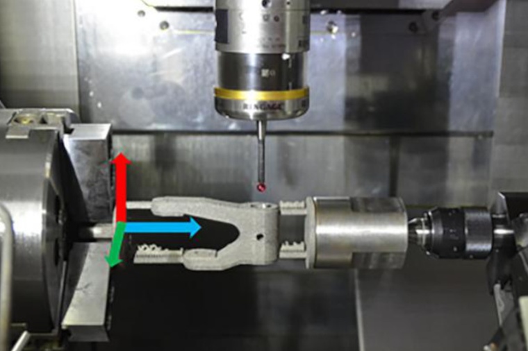A 3D-printed part mounted in the computer numerical control machine after...