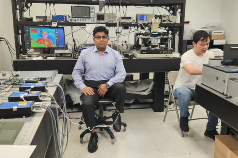 Debashis Chanda sits near an infrared camera image of himself in his lab....