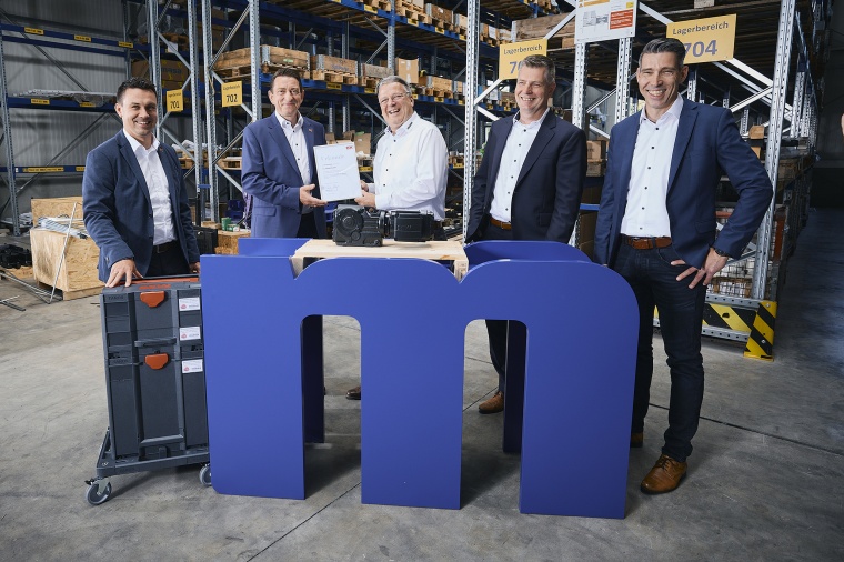 Patrik Menges (2nd from left), Sales Manager at SEW-Eurodrive Germany, hands...